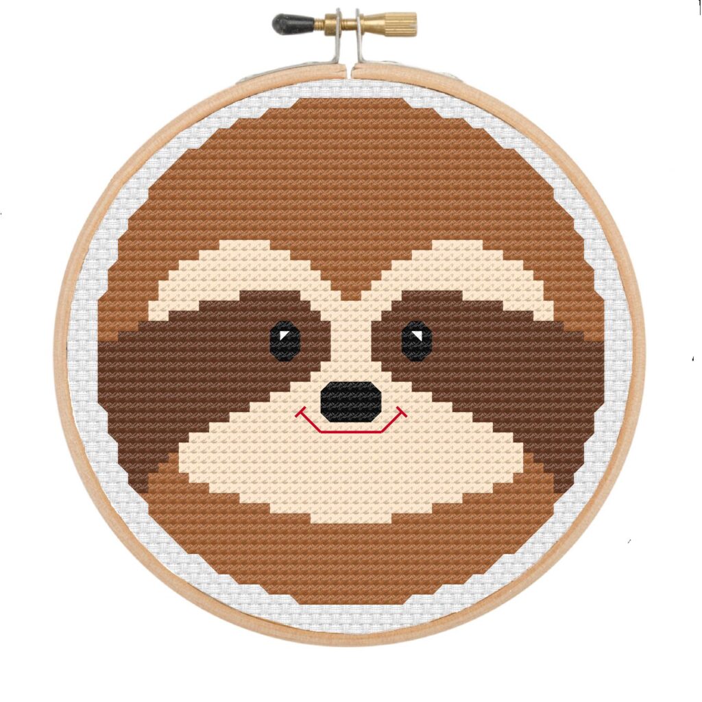 Sloth face cross stitch in wooden embroidery hoop