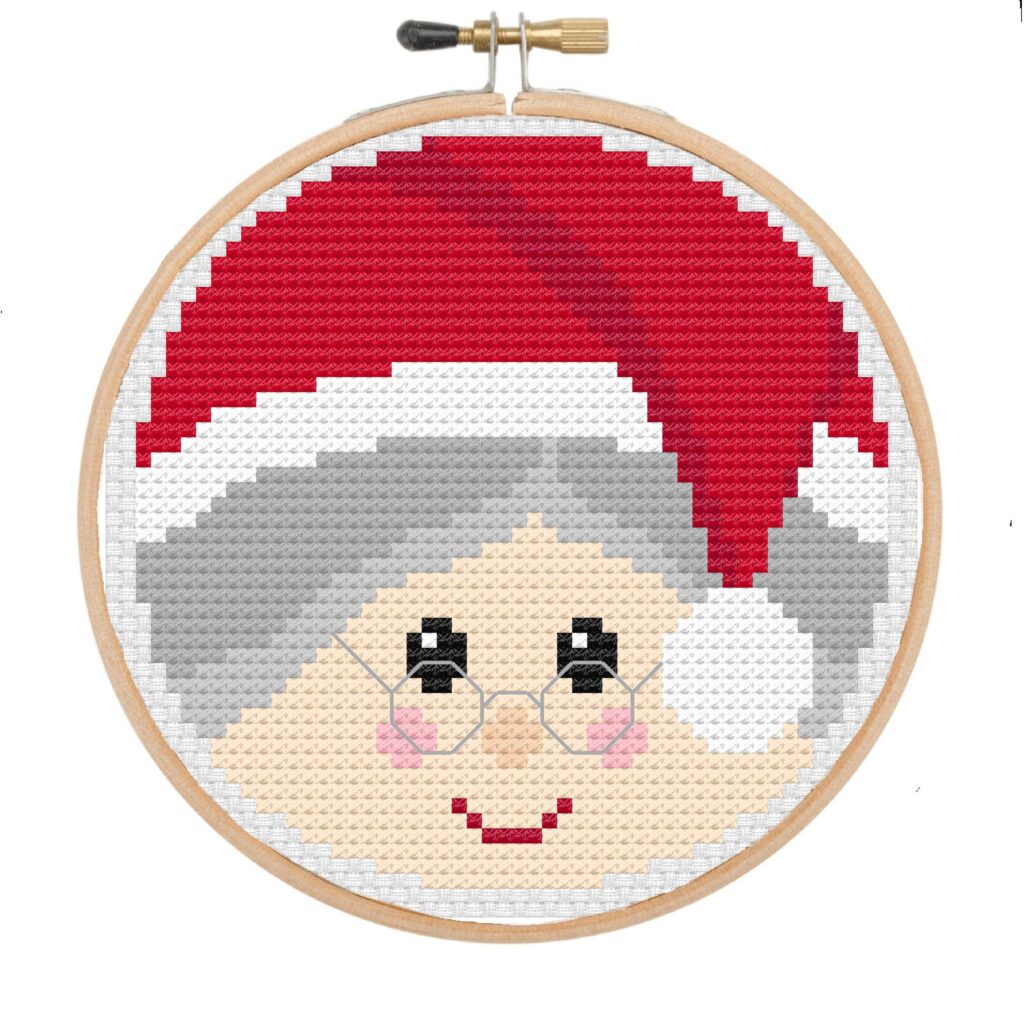 Mrs Claus face cross stitch in a wooden embroidery hoop