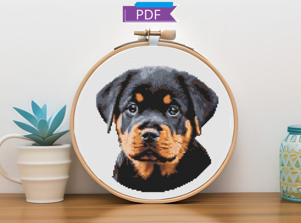 Rottweiler puppy cross stitch in an embroidery hoop